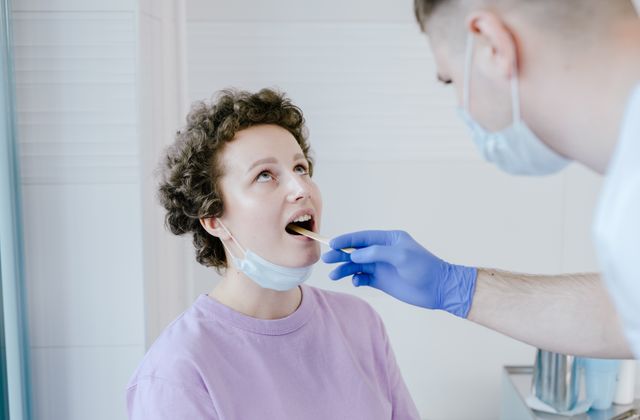 Doctor performing an oral exam