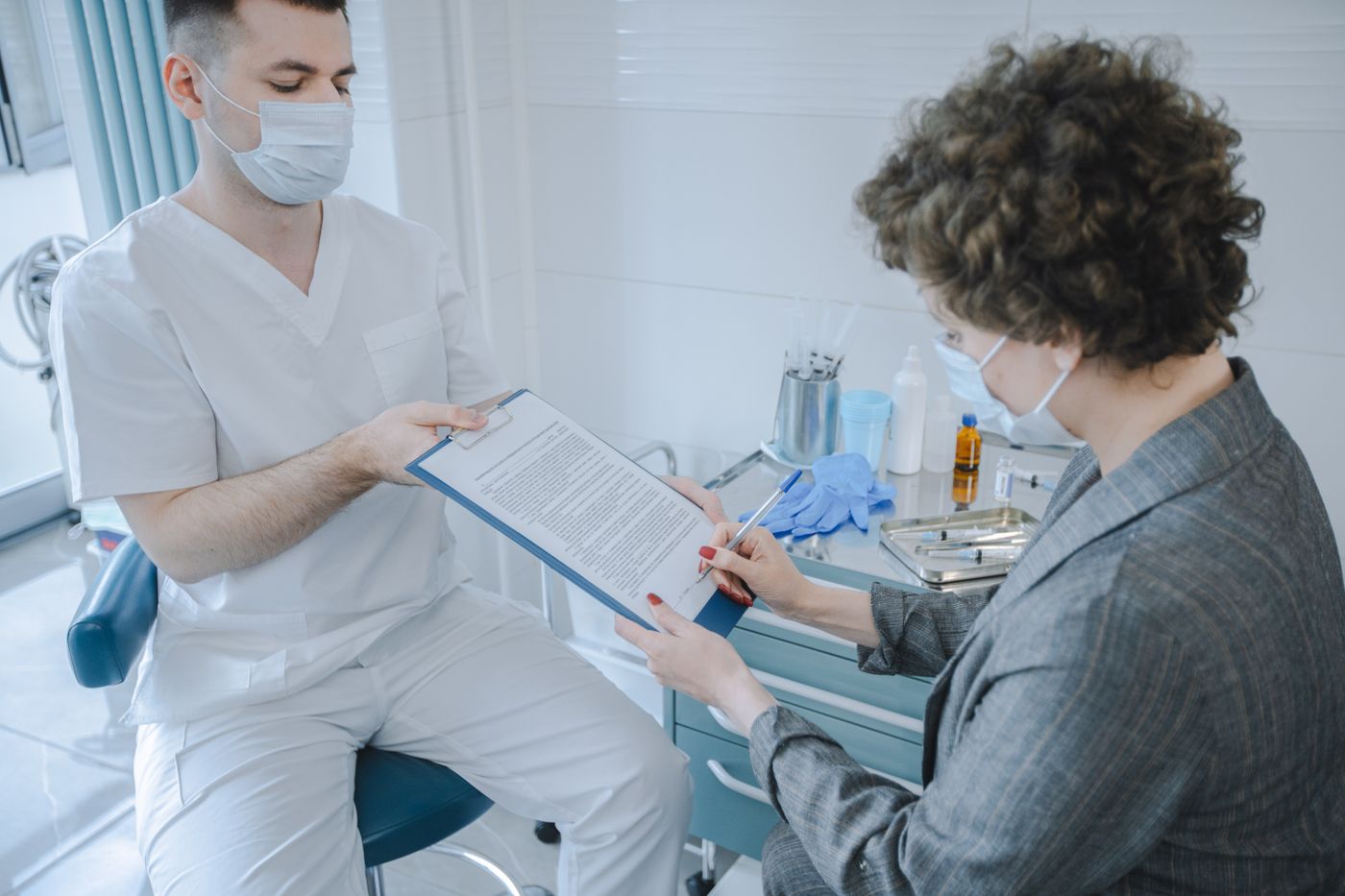 Patient reviewing healthcare documents with a clinician before psychiatric care
