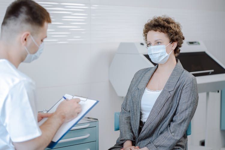 Doctor And Patient Talking In Office