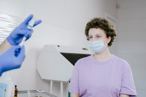 Free Curly Haired Woman Wearing a Face Mask Stock Photo