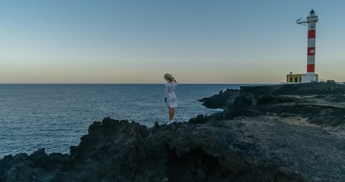 Free A Woman Standing on a Cliff Stock Photo