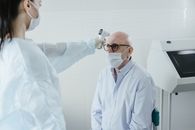 A Medical Professional Taking the Temperature of a Patient