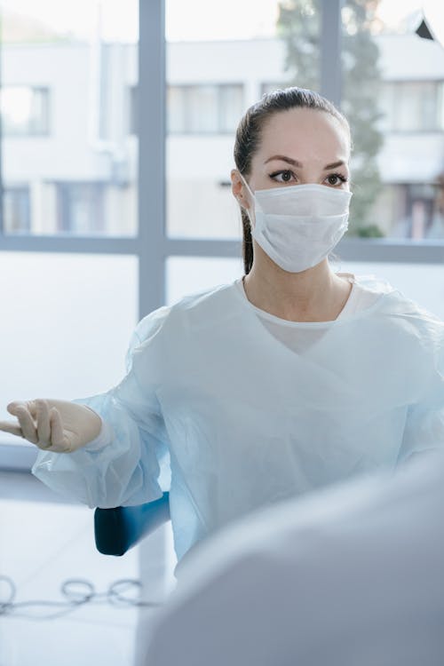 A Woman Wearing a Face Mask and a Disposable Gown