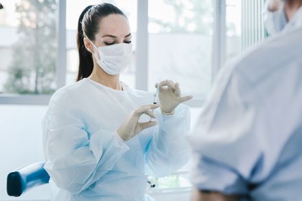 Scientist wearing safety goggles and gloves while handling chemicals
