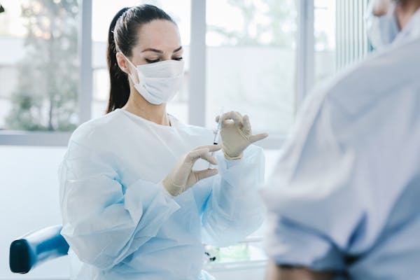 Scientist wearing gloves and safety goggles while handling chemicals