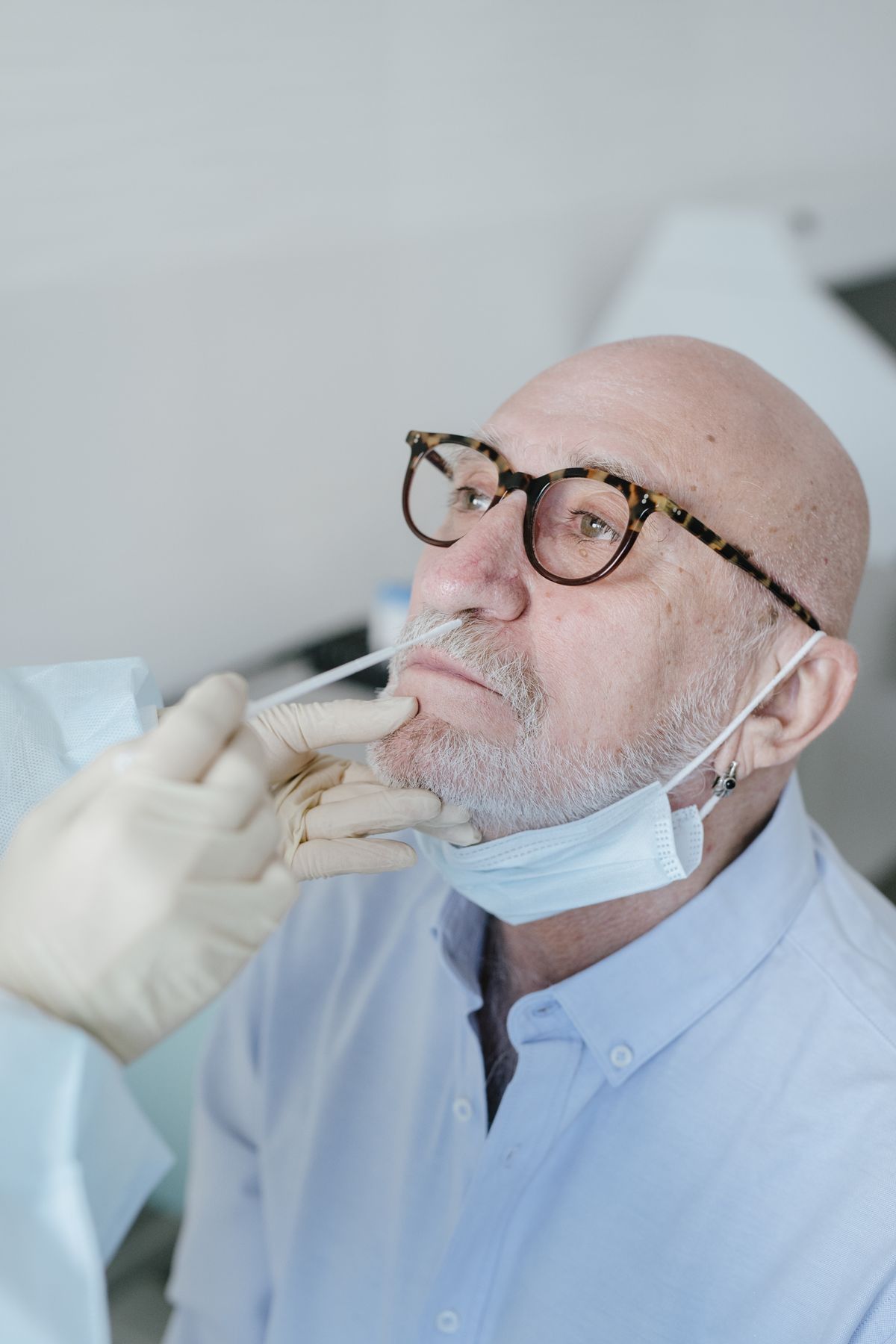 Person receiving a nasal swab COVID-19 test from a healthcare provider