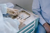 A Medical Professional Holding a Tray of Syringes