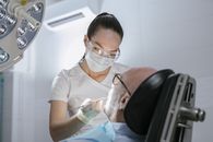 A Dentist doing a Procedure on a Patient