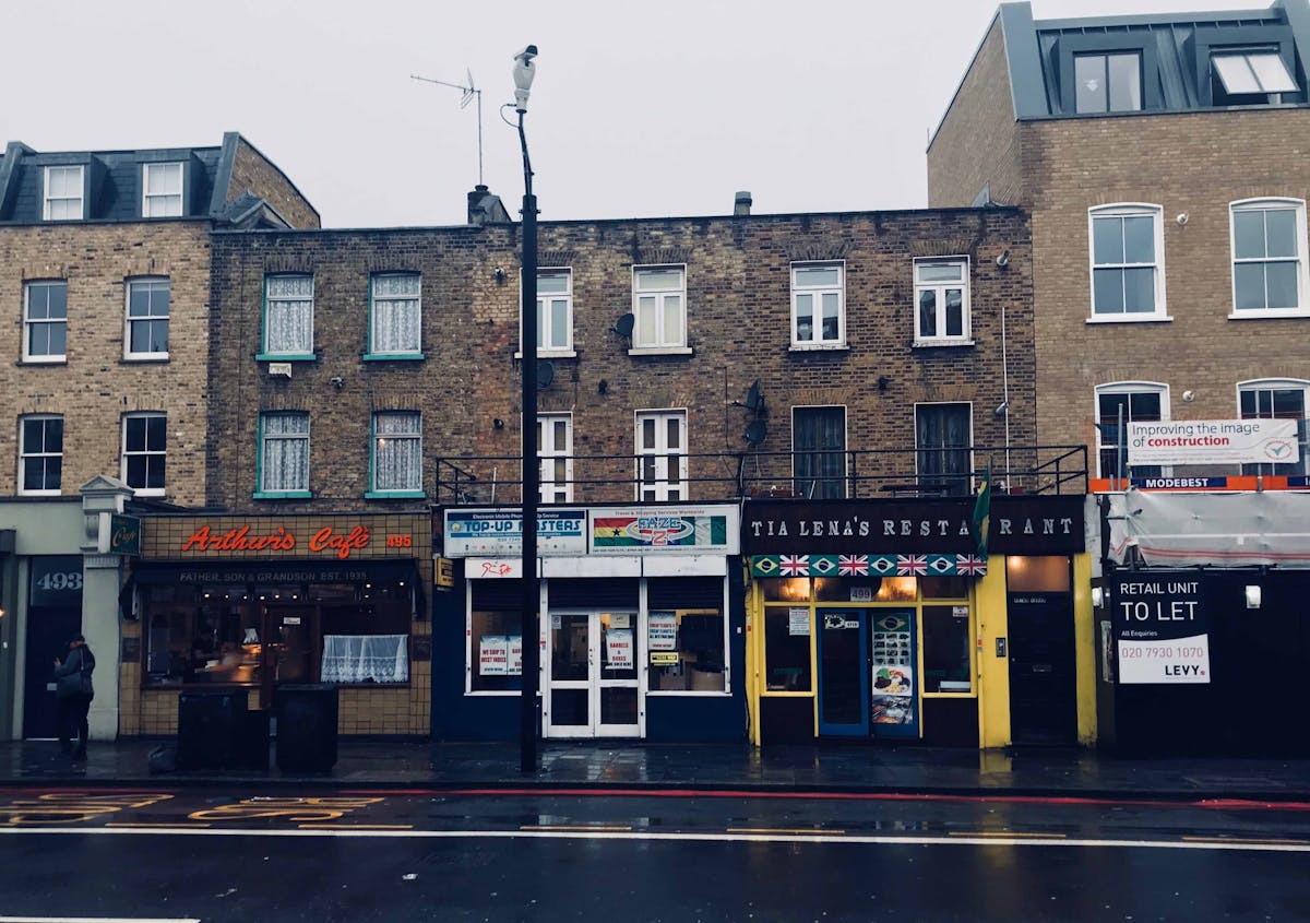 Person scrolling social media on a smartphone with food and coffee on the table