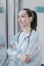 A Woman Wearing a Disposable Gown and a Stethoscope around Her Neck