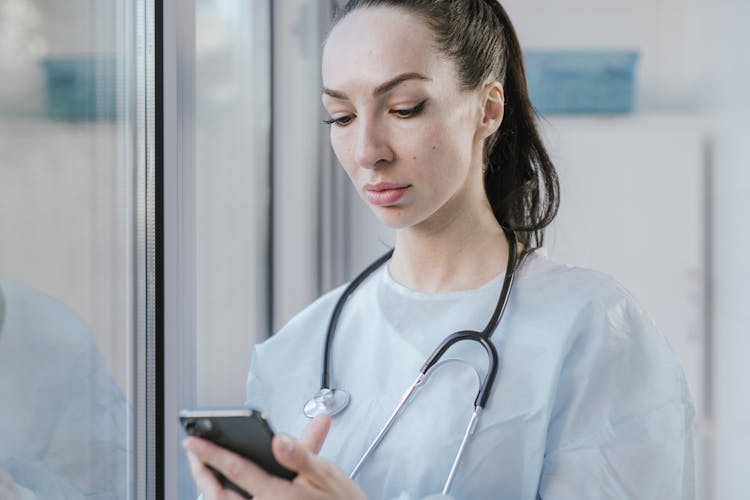 A Doctor Using Her Smartphone