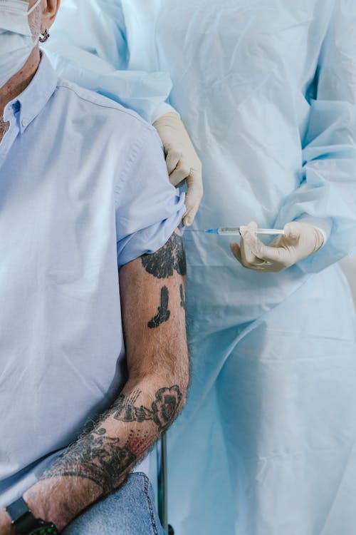 Free A Tattooed Person being Vaccinated Stock Photo