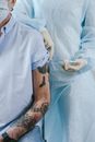 Person in White Dress Shirt With Black Tattoo on Right Arm