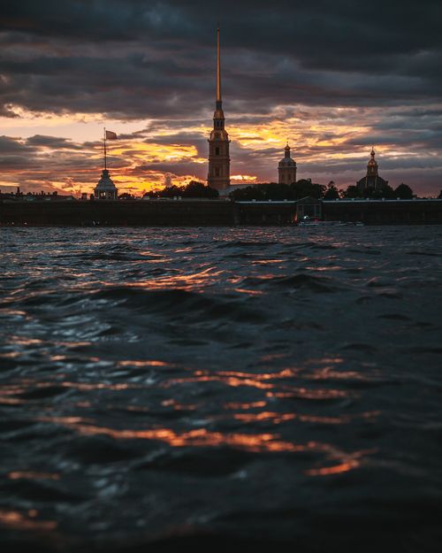 Free Dramatic sunset view over the waves at Peter and Paul Fortress in St. Petersburg, Russia. Stock Photo