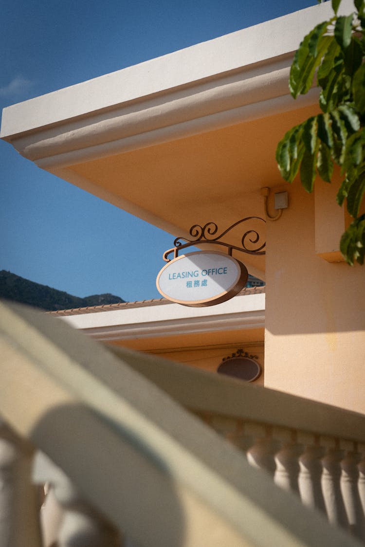 A Hanging Signage Of A Leasing Office