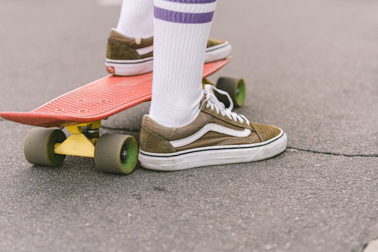 A Person Stepping On Skateboard