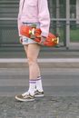 Woman in White Long Sleeve Shirt and Red Skirt Walking on Sidewalk