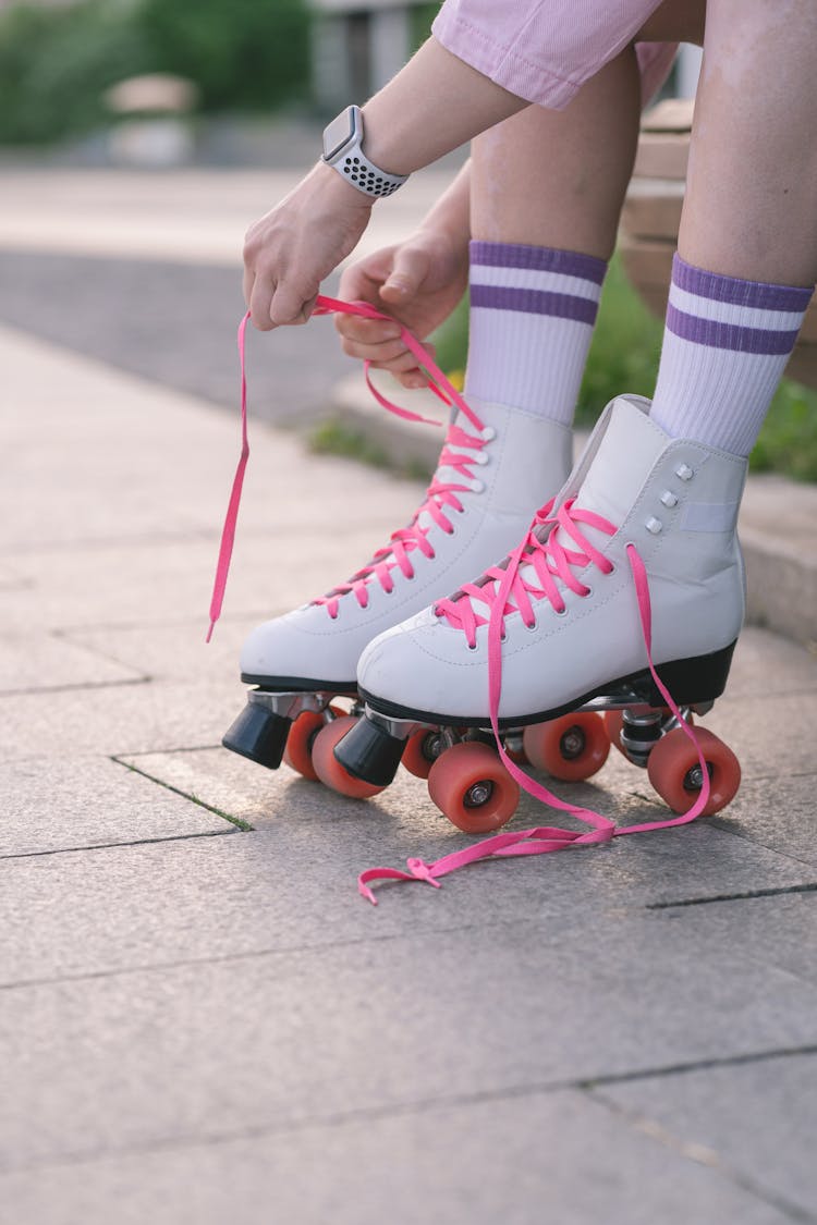 Close-Up Shot Of A Person Tying Rollerblades