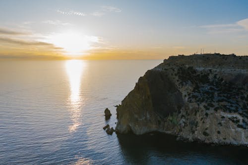 An Aerial Shot of a Cliff Coast during the Golden Hour