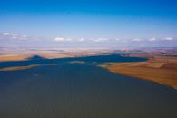 Aerial View of Brown Field Under Blue Sky