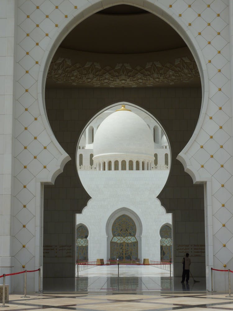 View Of White Mosque Through Entrance Gates