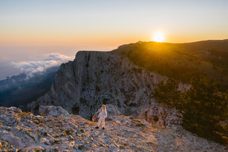 Woman On Top Of A Mountain With Her Baby