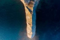 Brown Rock Formation on Body of Water