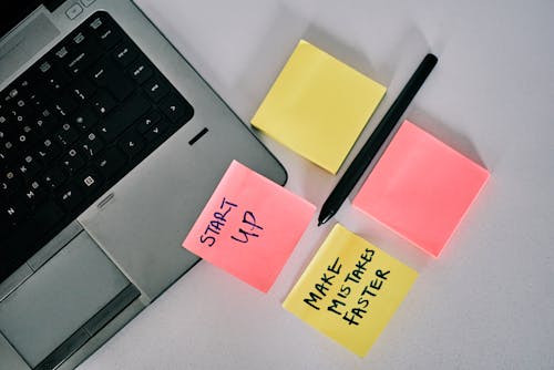 Sticky Notes Beside a Laptop