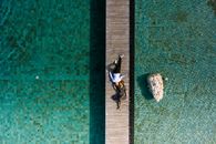 Aerial Footage of Couple on a Wooden Dock