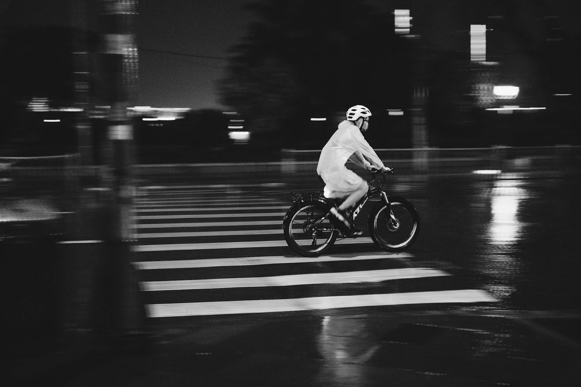 Monochrome Shot of a Person Riding a Bike