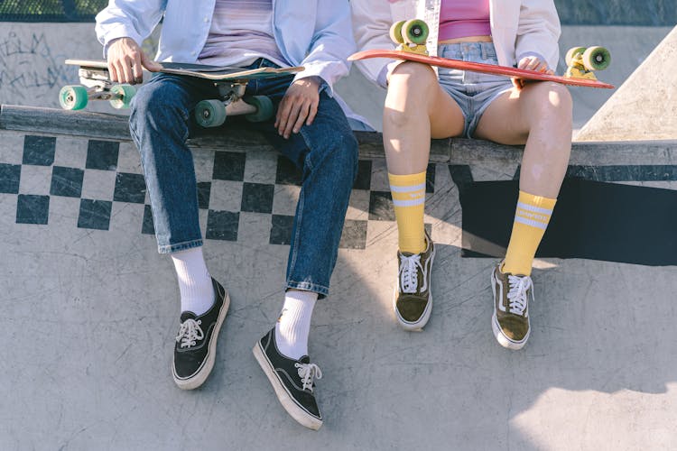 Man And Woman Sitting On A Skate Ramp