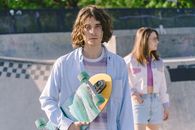 Woman in White Crew Neck T-shirt Holding Yellow and Green Skateboard