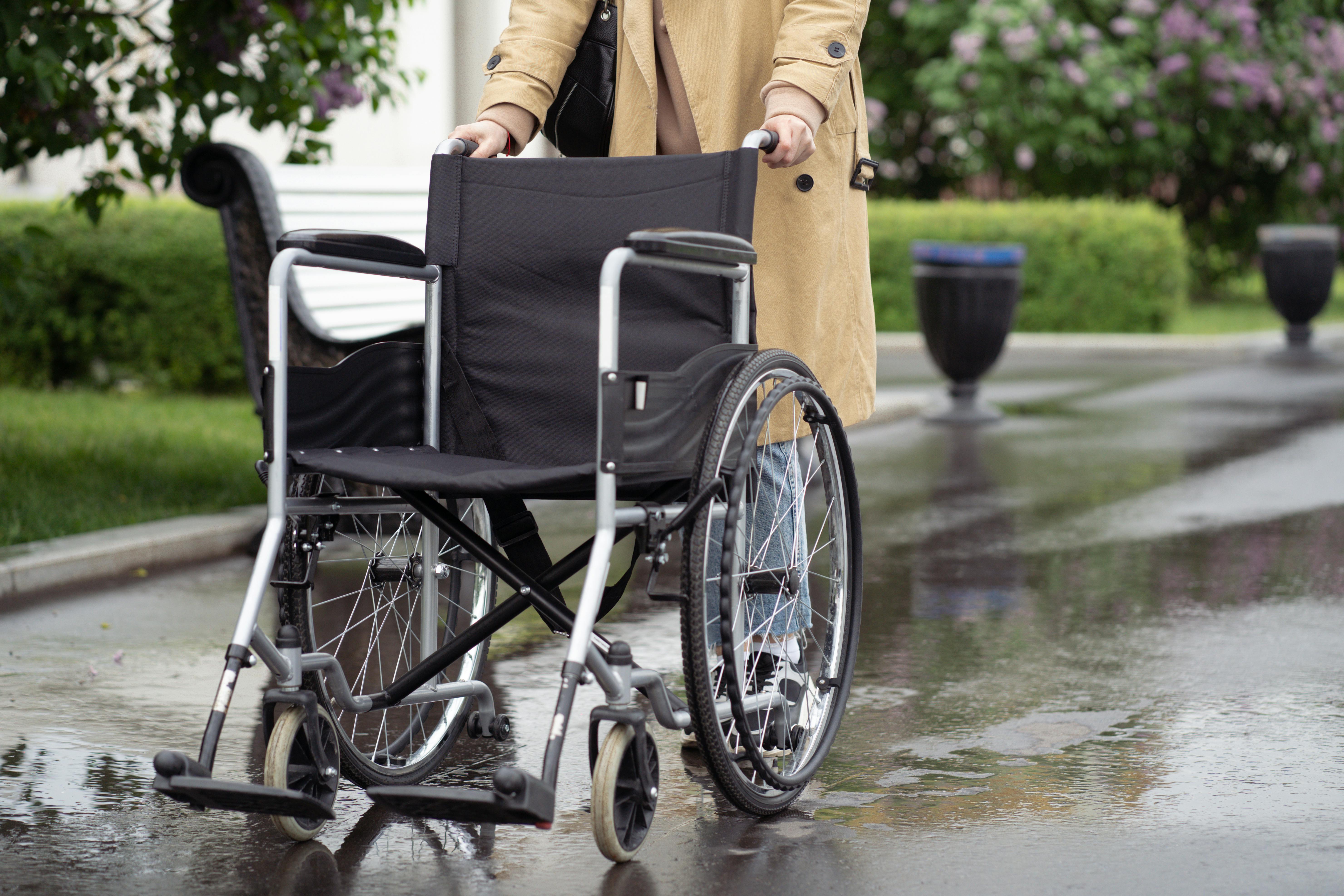 Person Pushing a Wheelchair · Free Stock Photo
