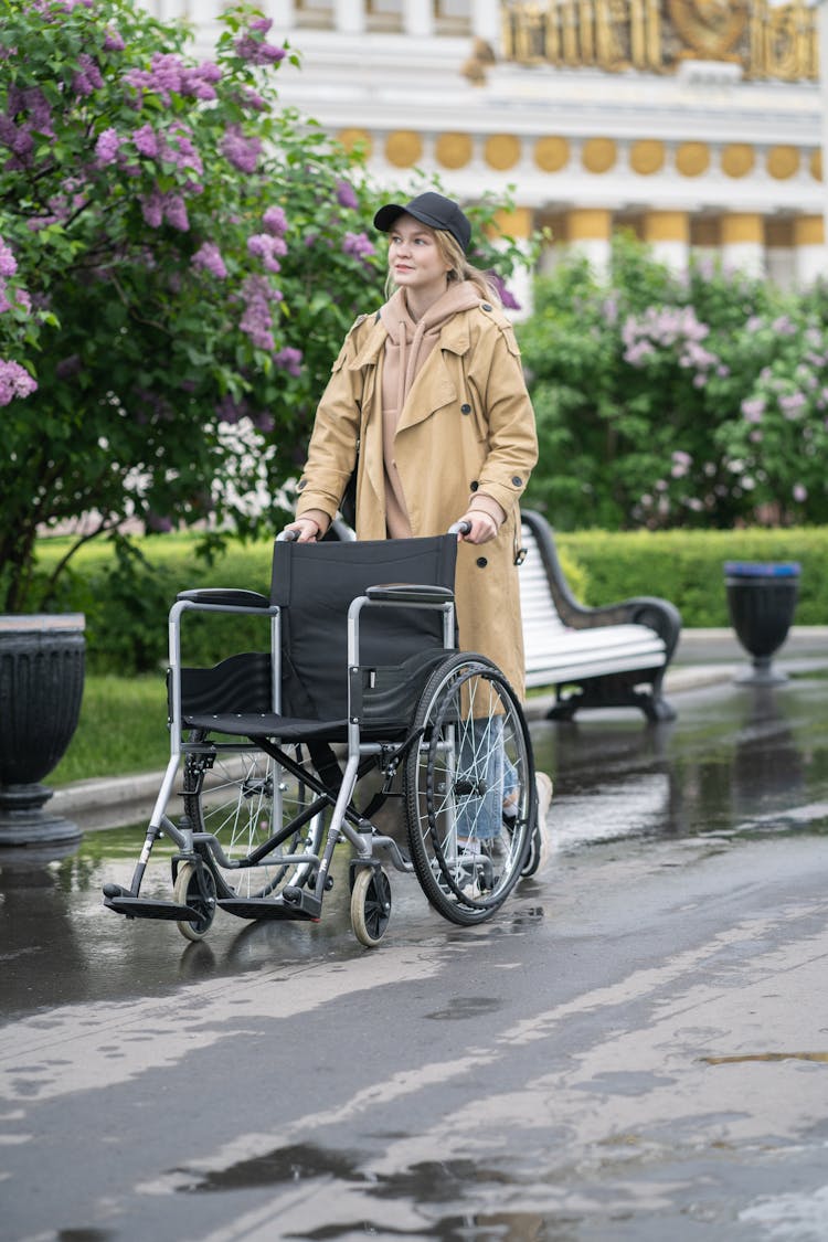 A Woman Pushing The Wheelchair