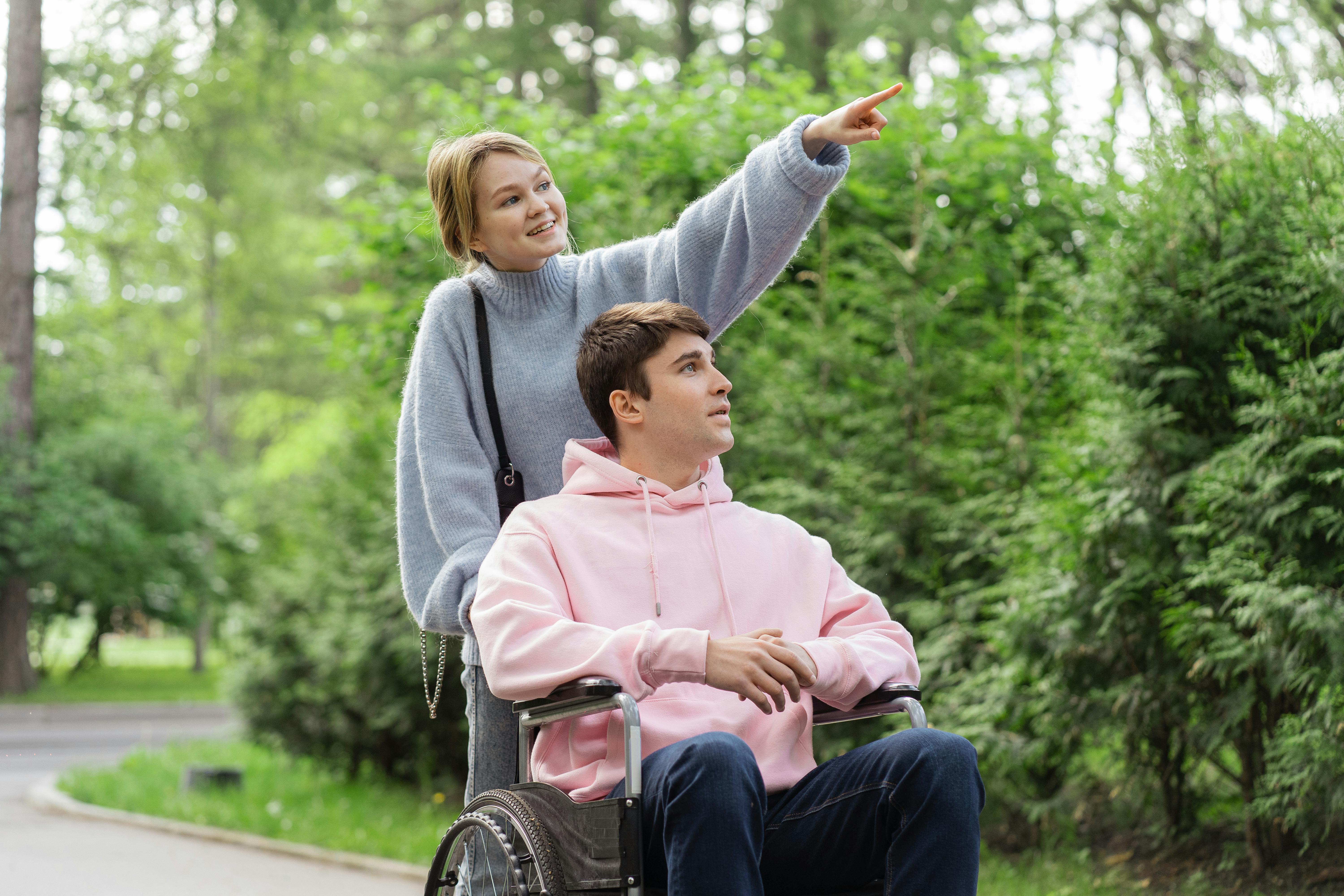 Woman Pushing The Wheelchair With A Man · Free Stock Photo