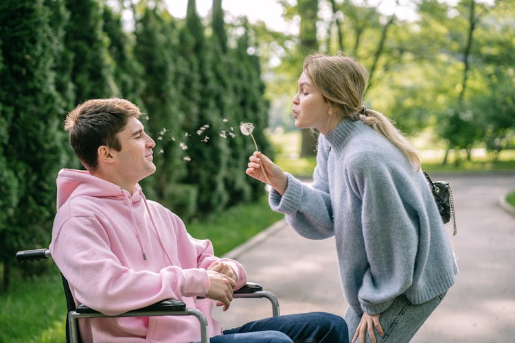 Woman Blowing Dandelion Flower