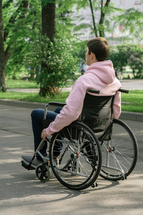 Free A Man in Pink Hoodie Sitting on the Wheelchair Stock Photo