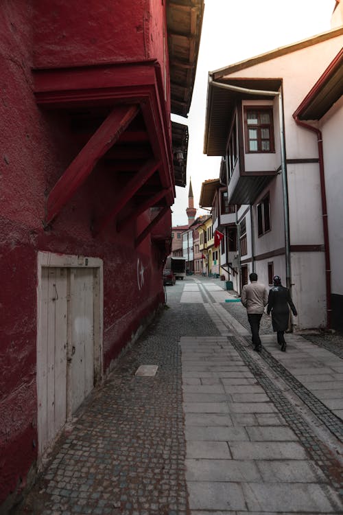 A Couple Walking on a Street in a City