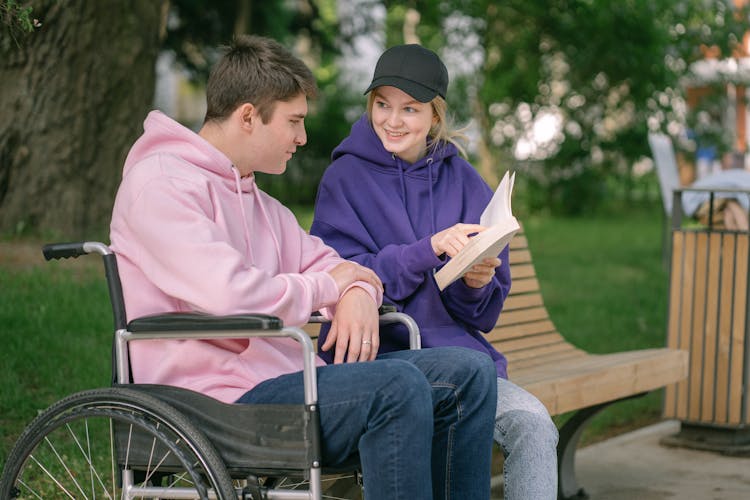 A Couple Reading A Book At The Park