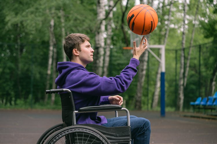 Man On Wheelchair Spinning A Ball