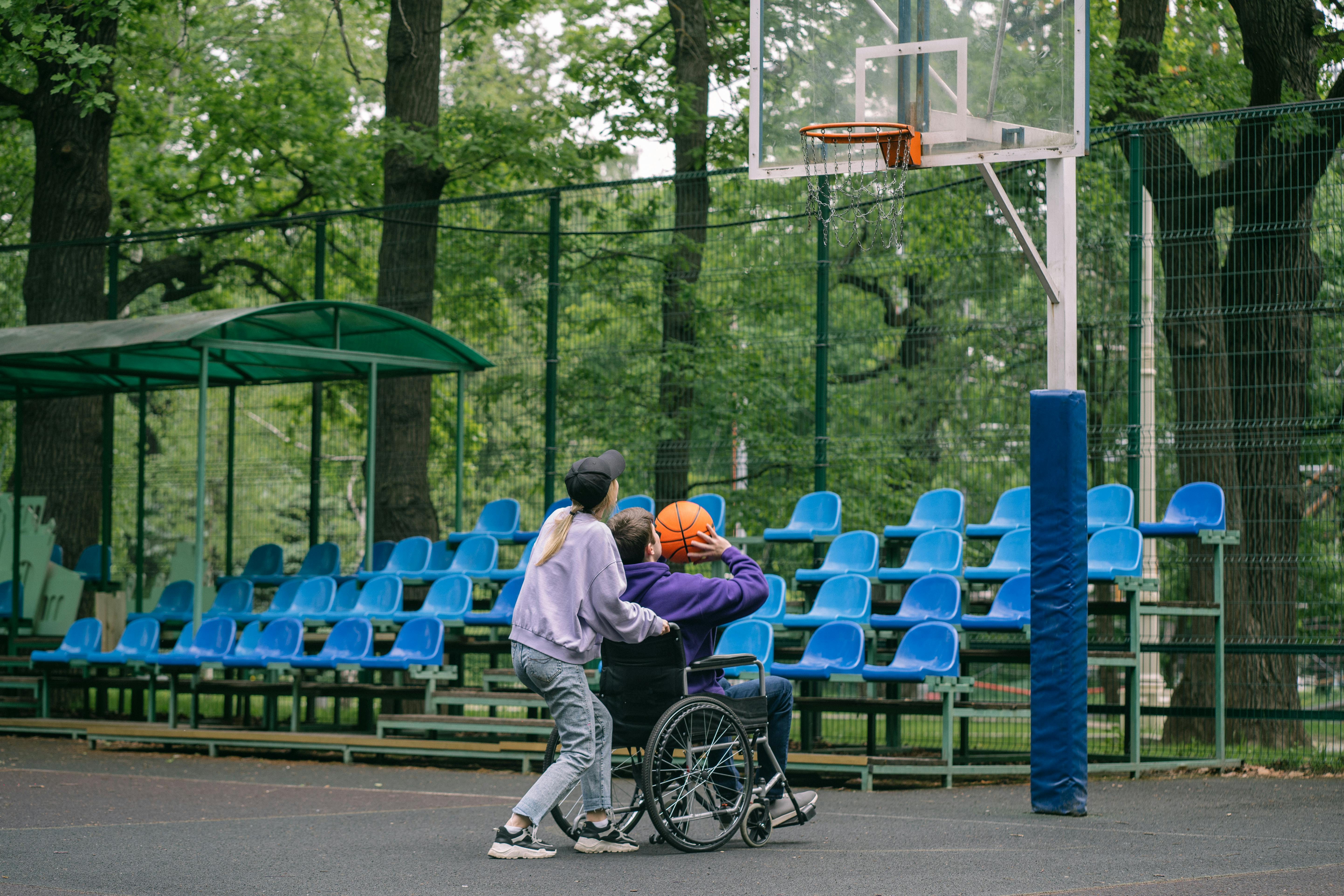 a man in a wheelchair shooting a ball