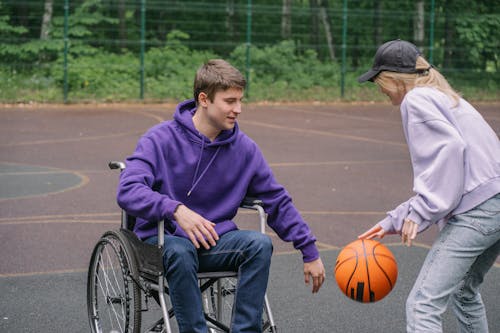Free A Man and Woman Playing Basketball Together Stock Photo
