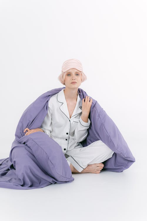 Free Woman in White Sleepwear with Blanket Over Her Shoulder Stock Photo