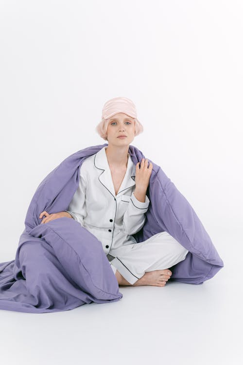 Woman in White Sleepwear with Blanket Over Her Shoulder