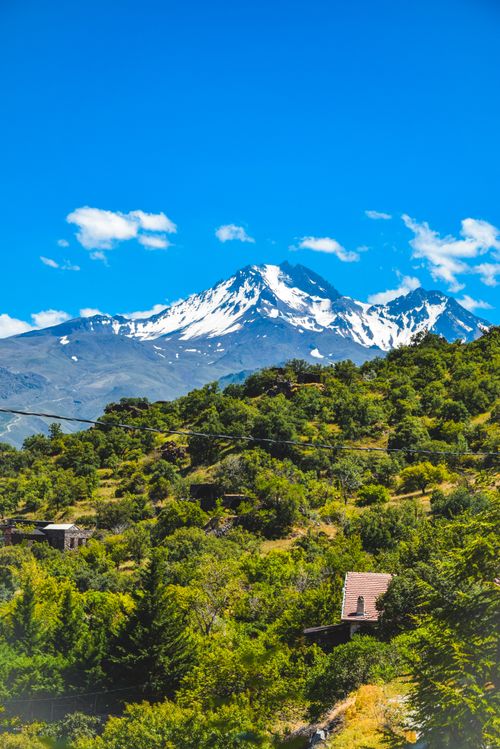 Free Breathtaking view of Mount Erciyes with lush greenery under a vibrant blue sky in Kayseri, Turkey. Stock Photo