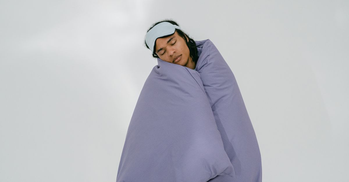 A person peacefully sleeping with an eye mask, wrapped in a purple blanket on a white background. - Evidence evidence guide for sleep hygiene insomnia
