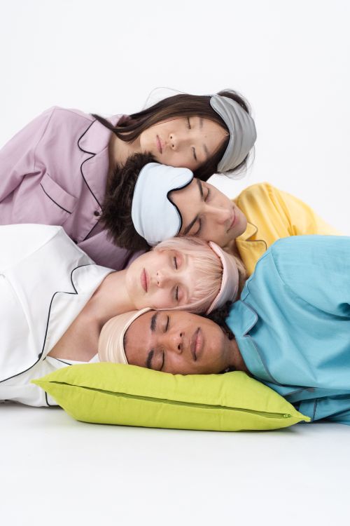Free A diverse group of young adults sleeping with sleep masks, symbolizing peaceful rest and harmony. Stock Photo