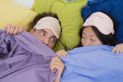 Free Man and Woman Lying on the Bed Stock Photo