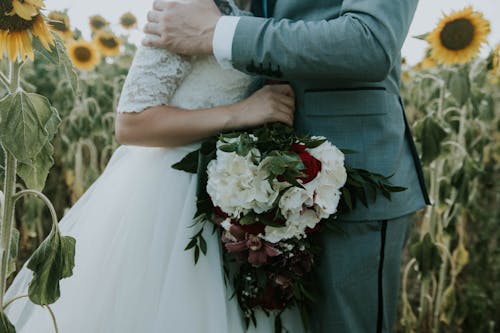 Man Embracing his Bride Holding a Bouquet