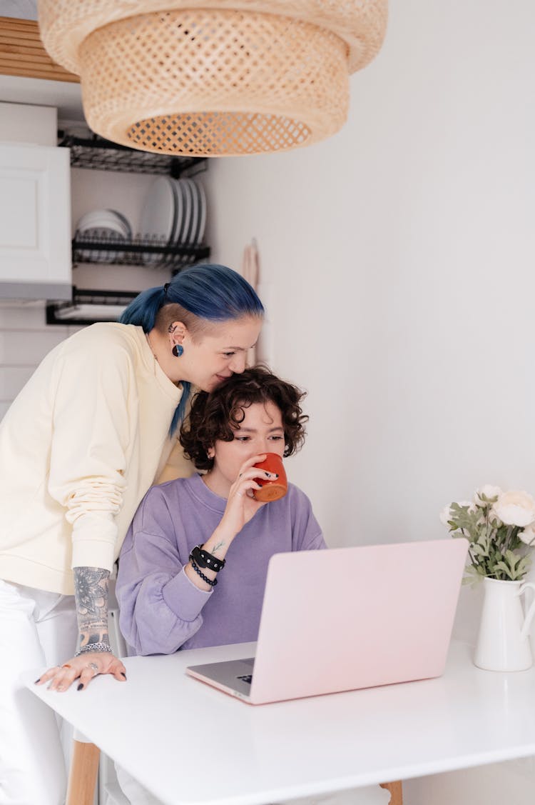 A Couple Looking At A Laptop